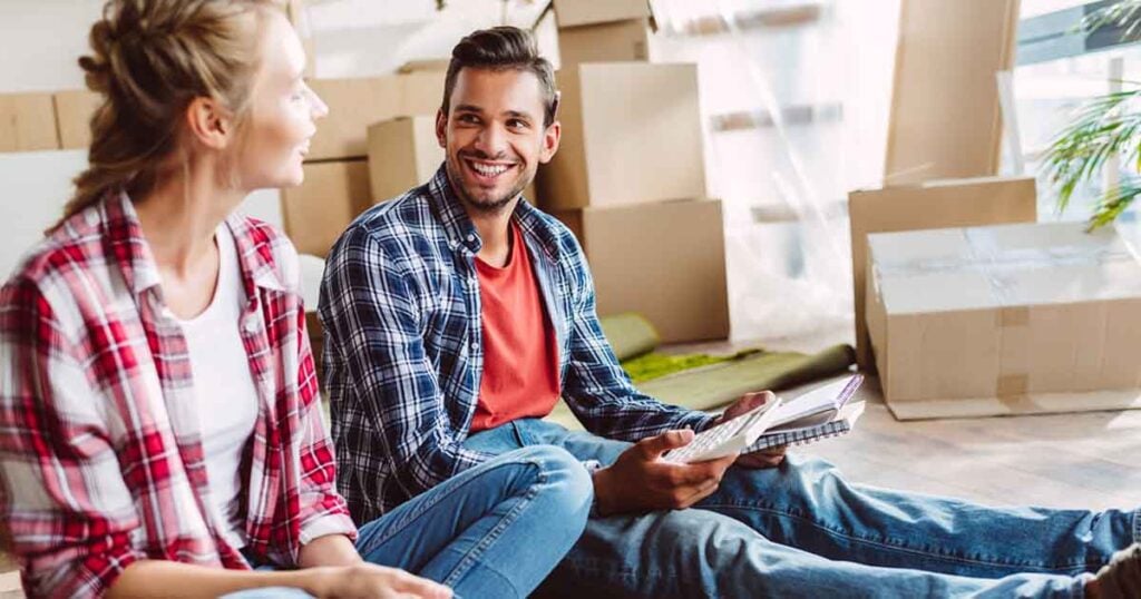 couple-sitting-on-floor-with-packing-boxes
